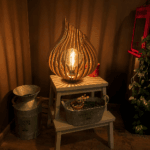 Lampe Flamme en bois allumée, présentée dans un intérieur chaleureux pour illustrer son rendu en situation.